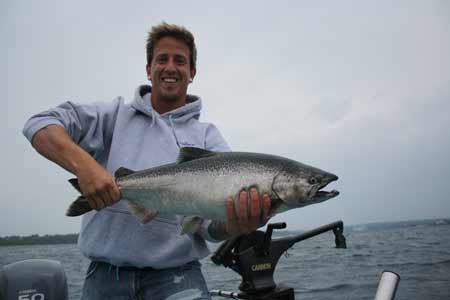 Owen Sound area local Adam Pettengill with a fine salmon caught in Owen Sound Bay.  Pettengill caught the fish on a Spin Doctor Flasher and brined anchovy combo.